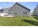 Well-manicured backyard featuring a lush lawn, patio, and tasteful landscaping near the house at 5465 Tanglewood Ln, Whitestown, IN 46075