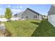 Home's backyard featuring a green lawn, patio, white fence, and a charming creek-side border at 5465 Tanglewood Ln, Whitestown, IN 46075