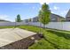 Beautiful backyard features a well-maintained lawn, concrete patio, and a white fence at 5465 Tanglewood Ln, Whitestown, IN 46075