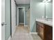 Well-lit bathroom featuring a single vanity, walk-in shower, and white barn door at 5465 Tanglewood Ln, Whitestown, IN 46075