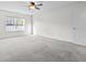 Bright bedroom featuring neutral carpet, a ceiling fan, and a window with natural light at 5465 Tanglewood Ln, Whitestown, IN 46075