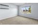 Bright bedroom with neutral carpet, a large window, and natural light at 5465 Tanglewood Ln, Whitestown, IN 46075