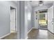 Inviting foyer with light-blue walls, decorative lighting, and an open doorway at 5465 Tanglewood Ln, Whitestown, IN 46075