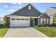 Well-maintained home with blue siding, brick accents, green lawn, and an attached two-car garage at 5465 Tanglewood Ln, Whitestown, IN 46075