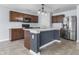 A well-lit kitchen with a large island, stainless steel appliances and plenty of cabinet space at 5465 Tanglewood Ln, Whitestown, IN 46075