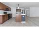A view of a kitchen with stainless steel appliances, a kitchen island, and sleek countertops at 5465 Tanglewood Ln, Whitestown, IN 46075