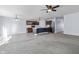 Spacious, open-concept living area with a kitchen island, fireplace, and ceiling fan at 5465 Tanglewood Ln, Whitestown, IN 46075