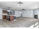Open concept living room and kitchen with modern appliances, an island, and fireplace at 5465 Tanglewood Ln, Whitestown, IN 46075