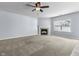 Cozy living room features a fireplace, neutral carpeting, and ample natural light at 5465 Tanglewood Ln, Whitestown, IN 46075