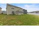 View of the home's backyard with a screened-in porch, grassy yard, and tasteful landscaping at 5845 Cresswell Ln, Whitestown, IN 46075