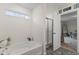 Bright bathroom with a soaking tub and glass-enclosed shower at 5845 Cresswell Ln, Whitestown, IN 46075