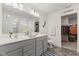 Bathroom with double vanity, tiled floors, and access to a large closet at 5845 Cresswell Ln, Whitestown, IN 46075