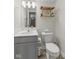 Cozy half bathroom with updated vanity, modern fixtures, and decorative shelving at 5845 Cresswell Ln, Whitestown, IN 46075