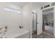 Bright bathroom featuring a soaking tub, glass shower, and large window at 5845 Cresswell Ln, Whitestown, IN 46075