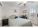 Bright bedroom featuring a window, ceiling fan, and a queen bed with decorative pillows at 5845 Cresswell Ln, Whitestown, IN 46075