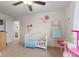 Sweet Bedroom with a white crib, ladder decor, and floral wall decorations creating a cozy space at 5845 Cresswell Ln, Whitestown, IN 46075