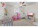 Adorable Bedroom with a crib, playhouse, and storage shelves with colorful bins at 5845 Cresswell Ln, Whitestown, IN 46075