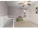 Spacious Bedroom with a crib, play area, and storage shelves with toys, perfect for a growing Gathering at 5845 Cresswell Ln, Whitestown, IN 46075