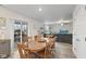 Open dining area with a wood table set, leading to a living room and sliding door to a patio at 5845 Cresswell Ln, Whitestown, IN 46075