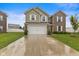 Charming home with a combination of light green siding and brick, a lawn, and a two-car garage at 5845 Cresswell Ln, Whitestown, IN 46075