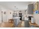 Modern kitchen featuring gray cabinetry, stainless steel appliances, an island, and wood-look flooring at 5845 Cresswell Ln, Whitestown, IN 46075