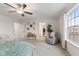 Airy bedroom with ceiling fan and a seating area leading to a bathroom and closet at 5845 Cresswell Ln, Whitestown, IN 46075