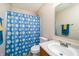 Bright bathroom features a daisy-patterned shower curtain, a vanity with sink, and a mirrored cabinet at 6209 Amber Valley Ln, Indianapolis, IN 46237