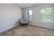Cozy room features a comfortable papasan chair between two windows, and carpeted flooring at 6209 Amber Valley Ln, Indianapolis, IN 46237