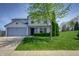 Charming two-story home featuring a well-maintained lawn and a classic blue siding at 6209 Amber Valley Ln, Indianapolis, IN 46237
