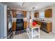 Kitchen features stainless steel appliances, wooden cabinetry, and ample counter space for cooking at 6209 Amber Valley Ln, Indianapolis, IN 46237
