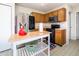 Bright kitchen features wooden cabinetry, stainless steel appliances, and a center island with breakfast bar at 6209 Amber Valley Ln, Indianapolis, IN 46237