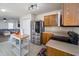 Spacious kitchen with stainless steel refrigerator, wooden cabinets, and a kitchen island with seating at 6209 Amber Valley Ln, Indianapolis, IN 46237