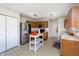 Well-lit kitchen with stainless steel appliances, wooden cabinetry, and an island for food preparation at 6209 Amber Valley Ln, Indianapolis, IN 46237