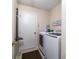 Bright laundry room features modern washer and dryer, convenient storage, and ample space for sorting and folding at 6209 Amber Valley Ln, Indianapolis, IN 46237