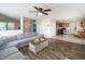 Open-concept living and kitchen area with a large grey sofa, hardwood floors, and stainless steel appliances at 6209 Amber Valley Ln, Indianapolis, IN 46237