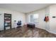 Bright office space with hardwood floors, a shelving unit, and natural light from a large window at 6209 Amber Valley Ln, Indianapolis, IN 46237
