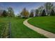 Well-maintained yard with a winding pathway and mature trees at 6209 Amber Valley Ln, Indianapolis, IN 46237