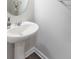 Simple bathroom features a pedestal sink with modern fixtures at 6229 Farlin Dr, Whitestown, IN 46075