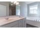 Bright bathroom features a double sink vanity, soaking tub, and a separate glass enclosed shower at 6229 Farlin Dr, Whitestown, IN 46075