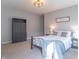 Well-lit bedroom featuring neutral carpeting, a gray armoire, and coordinated nightstands at 6229 Farlin Dr, Whitestown, IN 46075