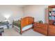 This is a bedroom with carpeted floors, and is decorated with wooden furniture at 6229 Farlin Dr, Whitestown, IN 46075