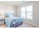 Cozy bedroom features a bed with a wrought iron frame and a bright window at 6229 Farlin Dr, Whitestown, IN 46075