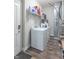 Laundry room with a white washer and dryer set, shelving for storage, and wood-look flooring at 6229 Farlin Dr, Whitestown, IN 46075