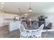 Open-concept living space featuring hardwood floors, white kitchen cabinets, and a dining area at 6229 Farlin Dr, Whitestown, IN 46075