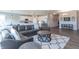 Bright, open floor plan with living room, dining area, and kitchen with white cabinets and gray backsplash at 6229 Farlin Dr, Whitestown, IN 46075