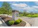 Community entrance sign with landscaping, brick accents, and street views of homes in the neighborhood at 6229 Farlin Dr, Whitestown, IN 46075