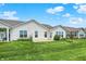 Wide backyard view showcasing a well-maintained lawn, home exterior, and beautiful landscaping details at 6241 Colonial Dr, Whitestown, IN 46075