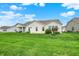 Expansive backyard with lush green grass, showcasing the home's exterior and outdoor living space at 6241 Colonial Dr, Whitestown, IN 46075