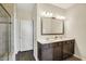 Bathroom with double sinks and a tiled shower with a glass door at 6241 Colonial Dr, Whitestown, IN 46075