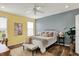Comfortable bedroom featuring light-colored walls, natural light, ceiling fan, and modern décor at 6241 Colonial Dr, Whitestown, IN 46075